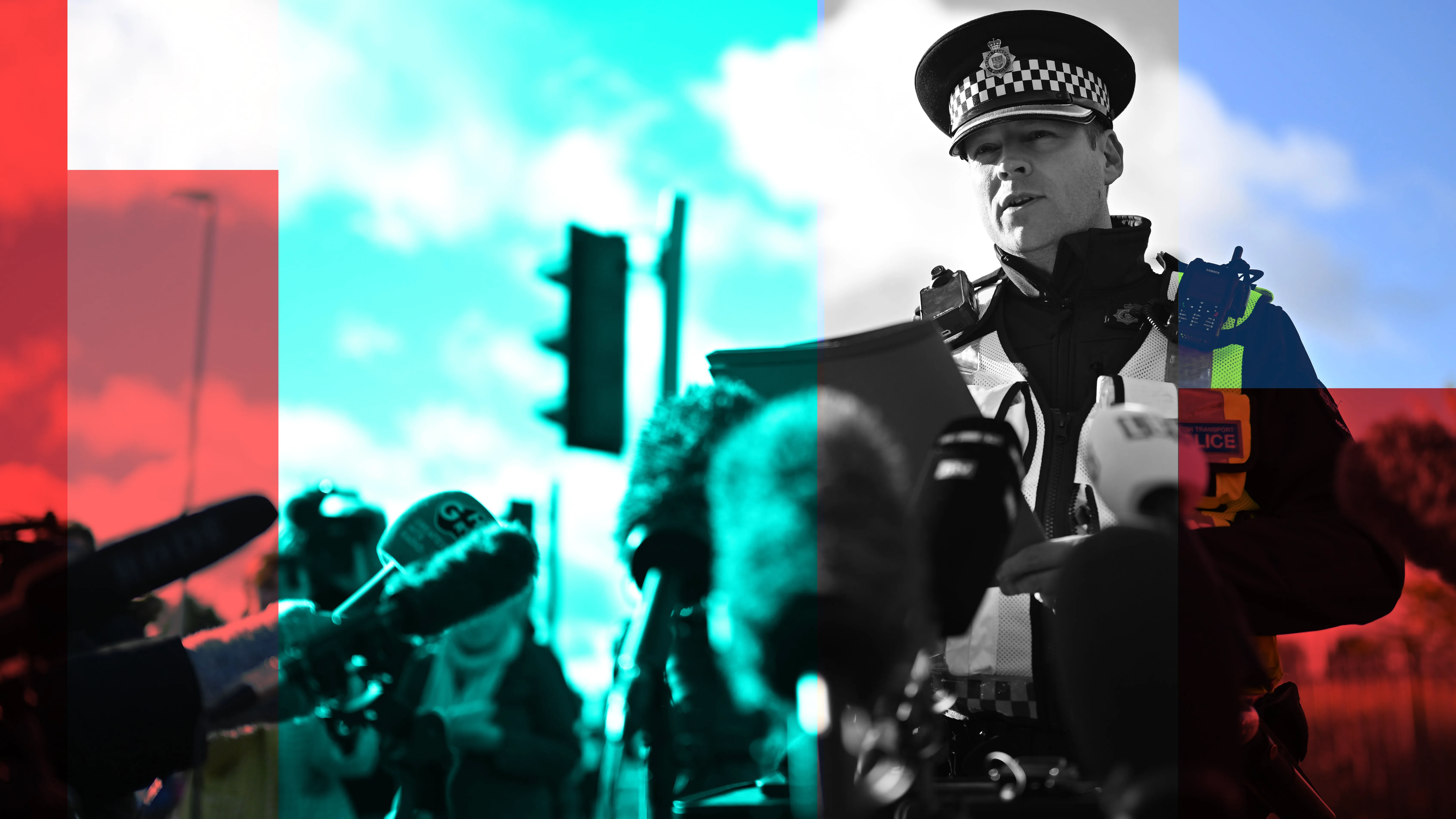 Policeman in uniform preparing to speak to the press, with lots of microphones in front of him